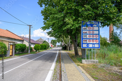 Big blue board with speed limits in Slovakia on entrance road to village Zahorska Ves (SLOVAKIA) photo