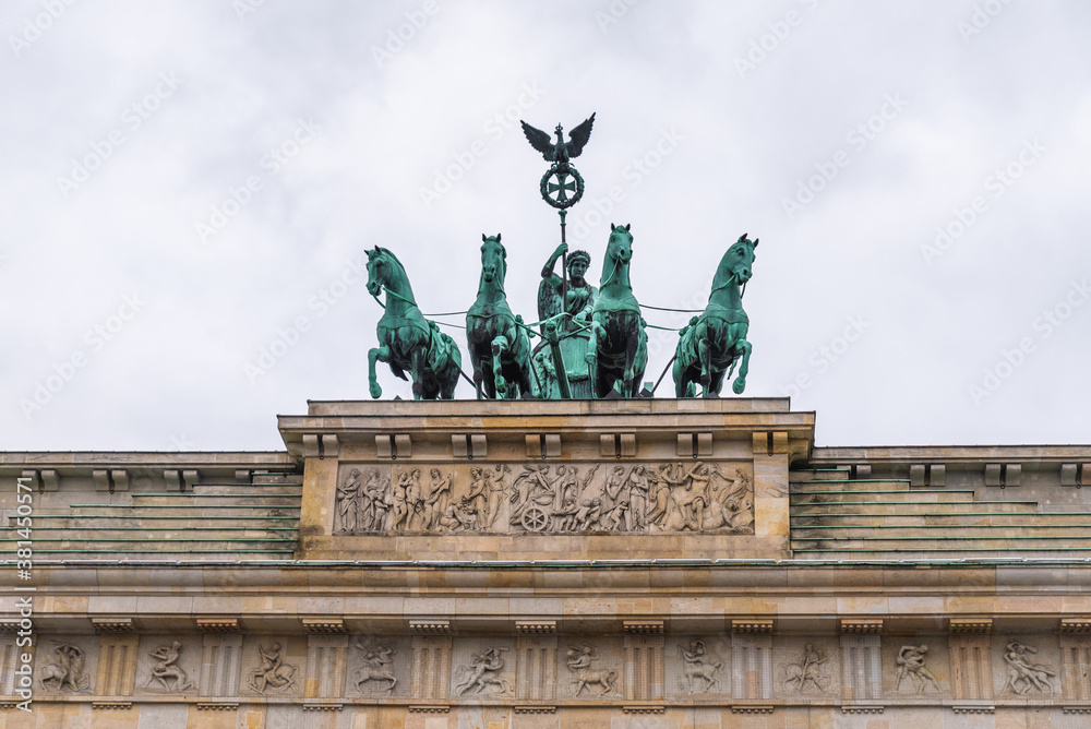 Fototapeta premium Quadriga of Victory, the teal statue with horses on top of the Brandenburg Gate on a winter day