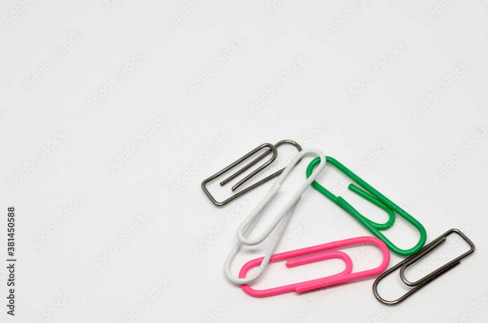 Five paper clips. White background, close-up, isolated. Five paper clips. White background, close-up, isolated.