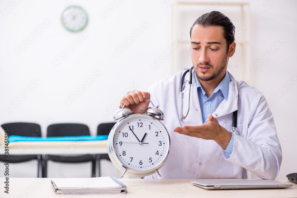 Young handsome male doctor working in the clinic Young handsome male doctor working in the clinic