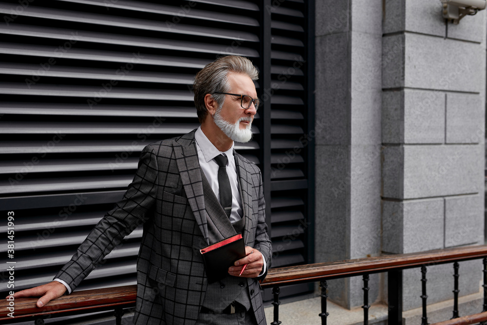serious 50-60 years businessman stand in contemplation outside, think about business plans and meetings, posing, looking away, in formal elegant wear, suit serious 50-60 years businessman stand in contemplation outside, think about business plans and meetings, posing, looking away, in formal elegant wear, suit