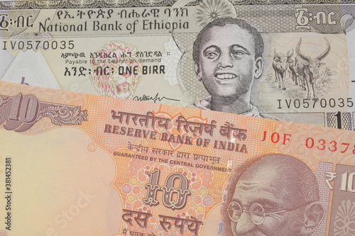 Wallpaper Mural A macro image of a orange ten rupee bill from India paired up with a grey Ethiopian one birr bill.  Shot close up in macro. Torontodigital.ca