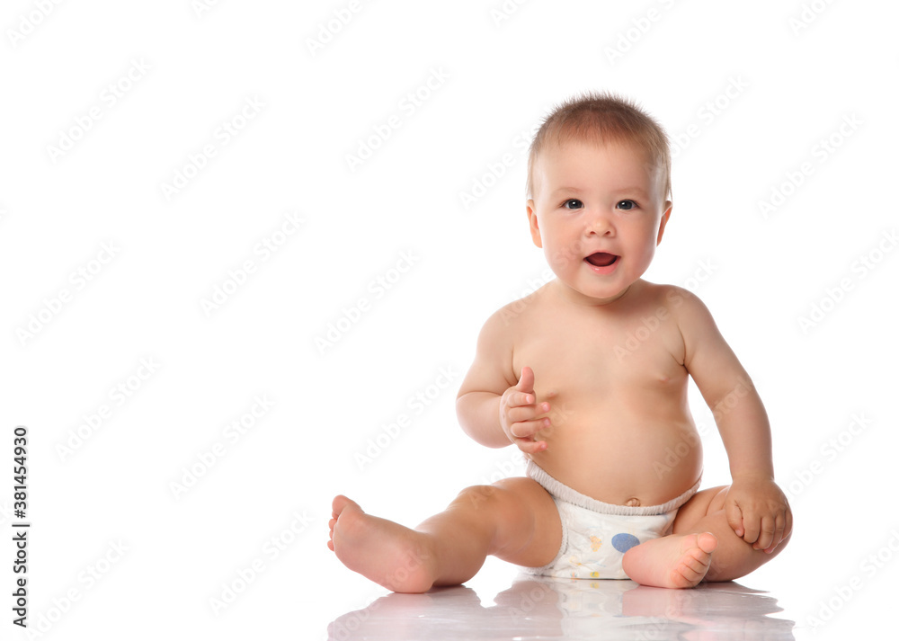 Emotional baby boy child on white studio floor Emotional baby boy child on white studio floor
