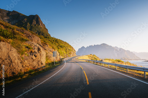 Schilderij op canvas road by the sea in sunrise time, Lofoten island, Norway