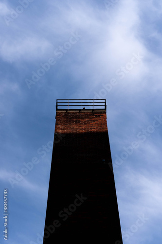 Old chimney with shadow and blue sky