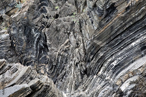 sharp rock layers at the coast of liguria in cinque terre north italy. Stone Texture background wallpaper