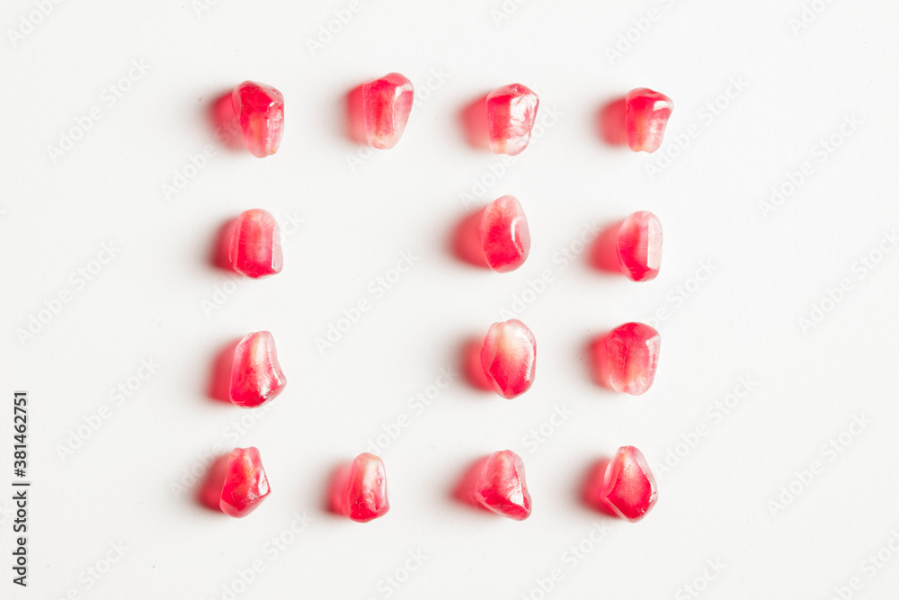 pomegranates square group of seeds isolated on white background pomegranates square group of seeds isolated on white background