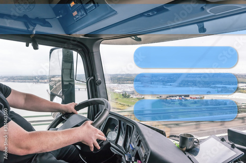 Interior of a truck cab with a driver while driving. Blank rectangles are ready for your use as template, information or presentation.