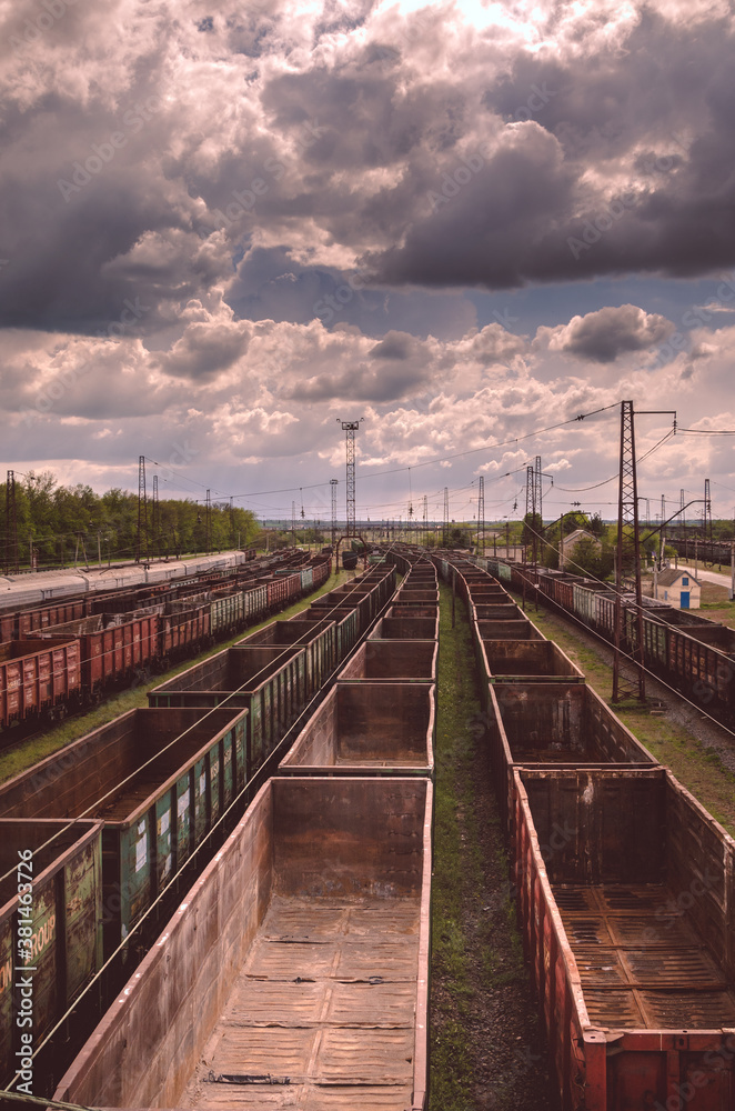 Freight station with a large number of cars lined up in a straight line. Freight station with a large number of cars lined up in a straight line.