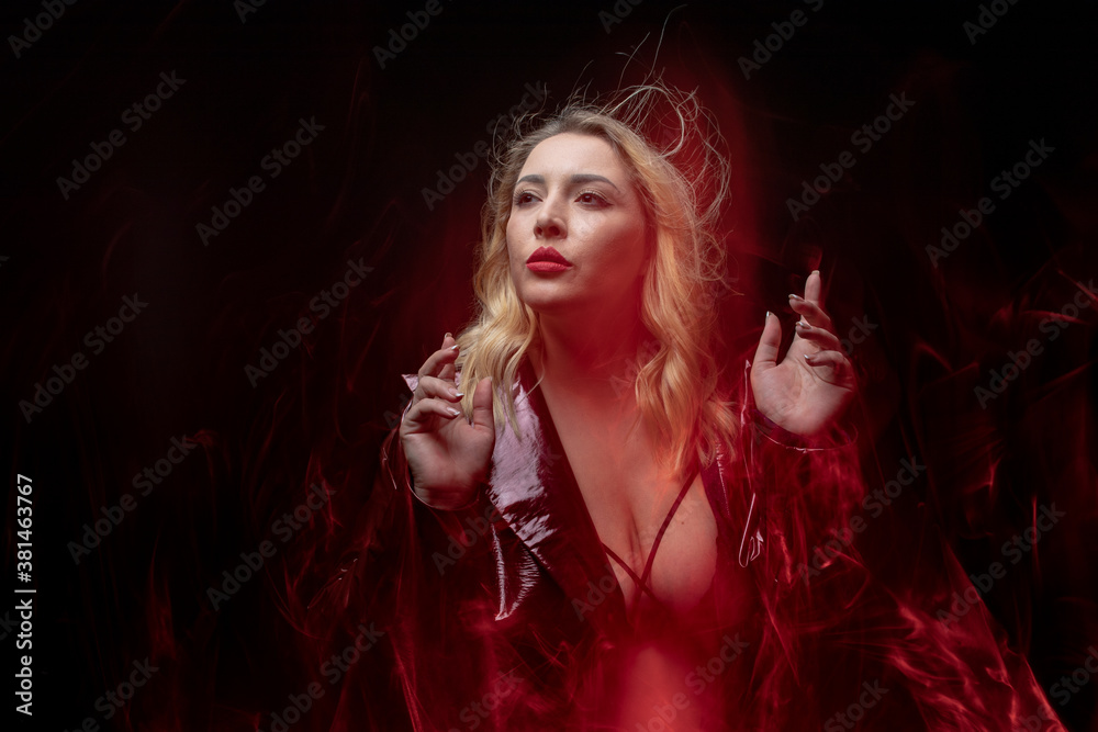 Closeup portrait woman body positive naked posing in sensuality scenic at black background with red tones. Beauty erotic blond model in sensual suit. Cinematic of plus size lady on studio shot