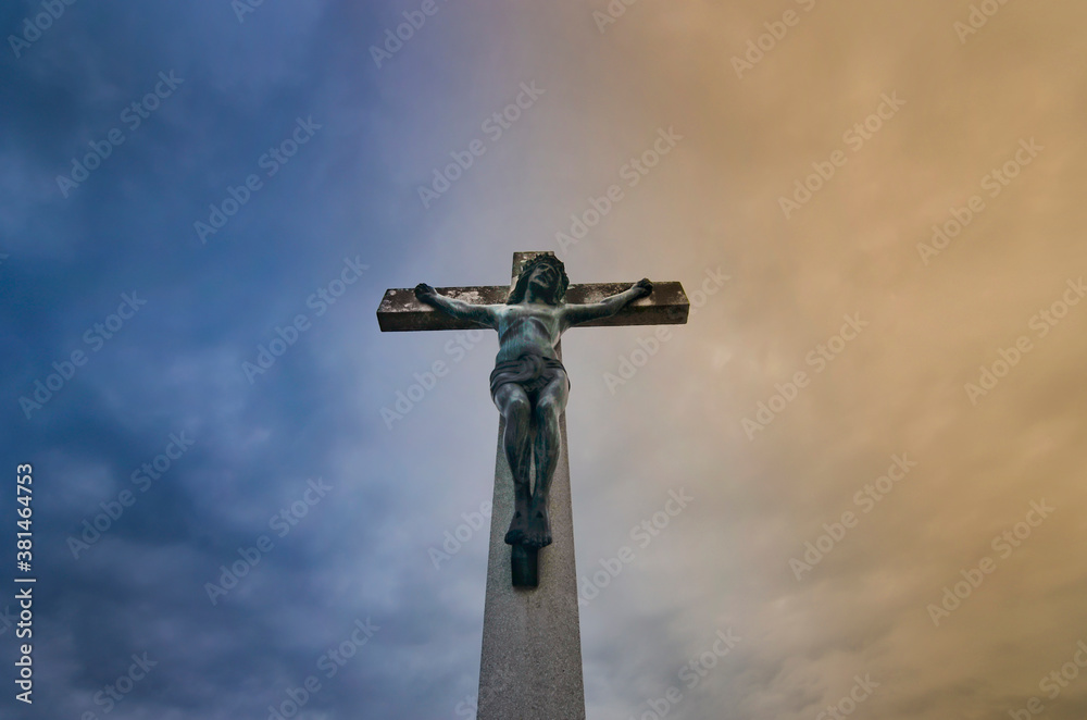 Jesus Christ on the cross against dramatic cloudy sky