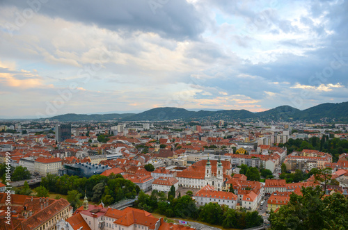 Cloudy sunset over the city of Graz, with Mariahilfer church and historic buildings, in Styria region, Austria