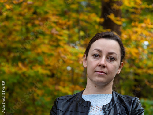 girl on a walk in the Park. the yellow foliage. autumn. Wellness walks in the fresh air.
