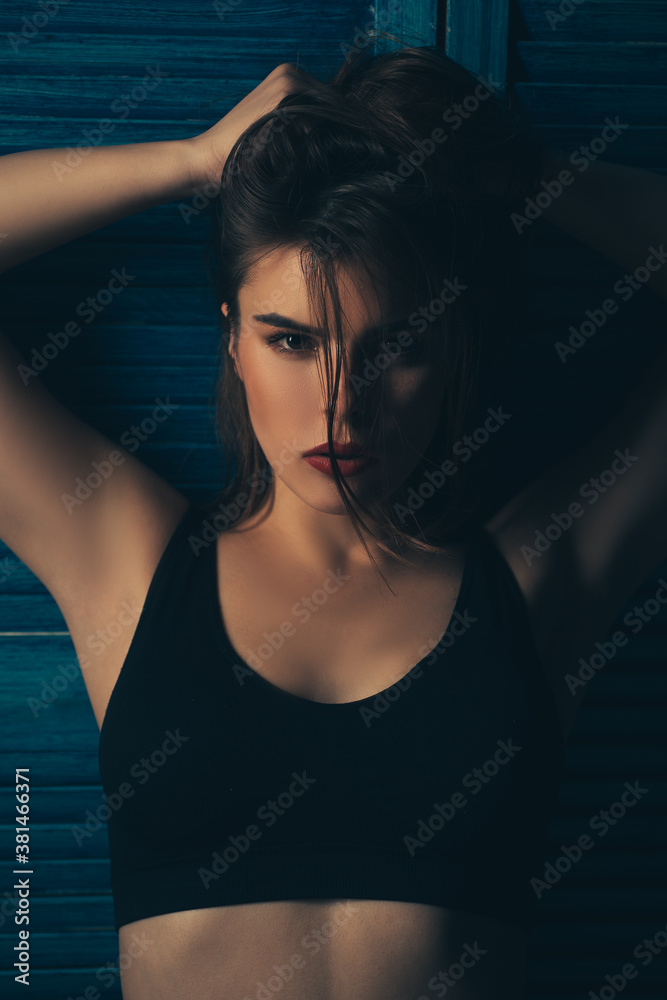 Beautiful woman fashion art studio portrait with windy hair and dark light. Portrait of a beautiful sensual brunette girl on dark background. Beautiful woman fashion art studio portrait with windy hair and dark light. Portrait of a beautiful sensual brunette girl on dark background.