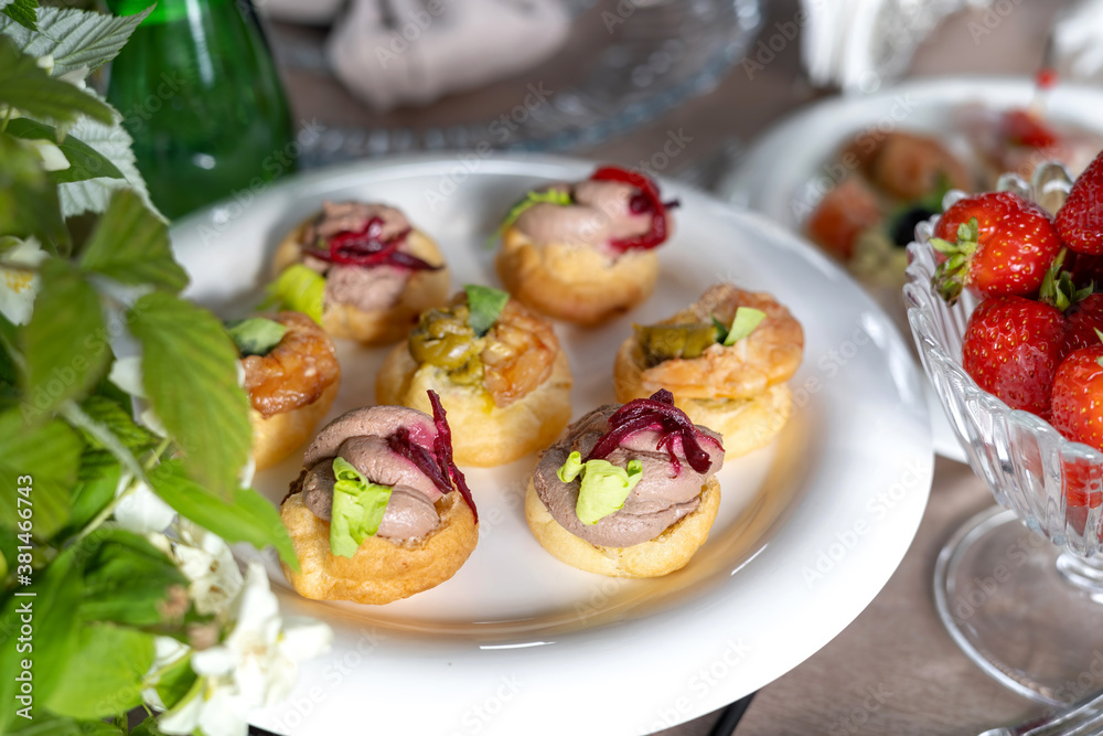 Savory profiteroles with different types of fillings. An exquisite French snack for a buffet at the feast.