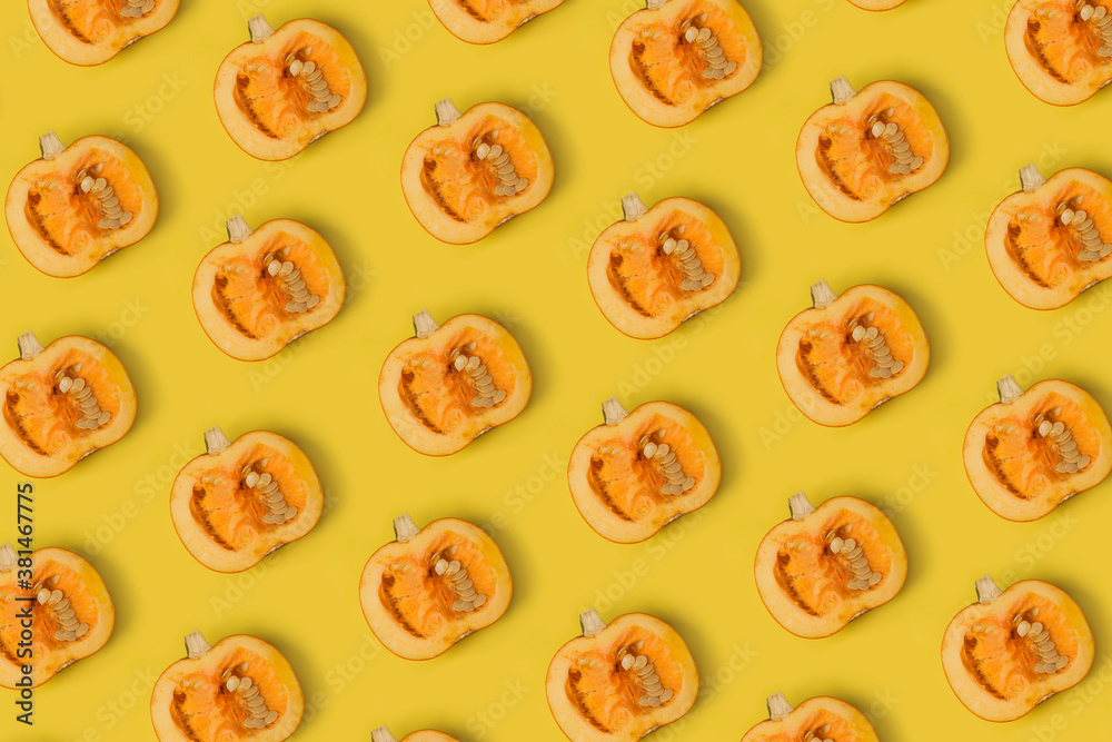 Cut pumpkin pattern on yellow background. Top view Cut pumpkin pattern on yellow background. Top view