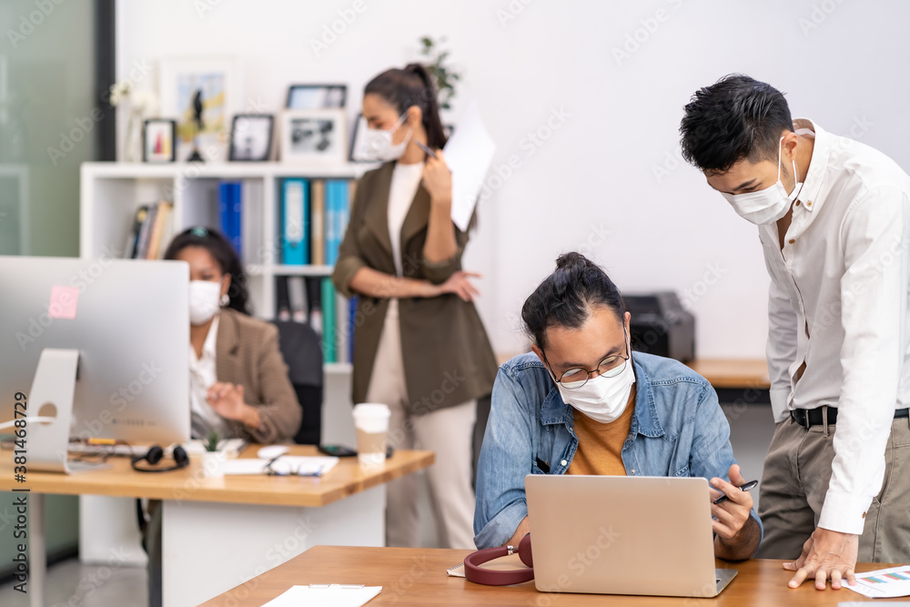 Social distance office with business team wear face mask as new normal life Social distance office with business team wear face mask as new normal life