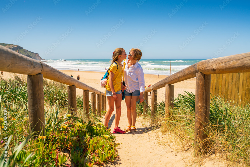 Mother and Daughter Kissing at the Beach