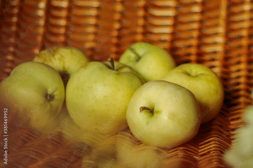 still life with yellow apples on a wicker wooden chair. selective focus still life with yellow apples on a wicker wooden chair. selective focus
