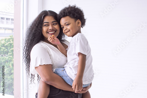 African mom carrying her son and staying at home
