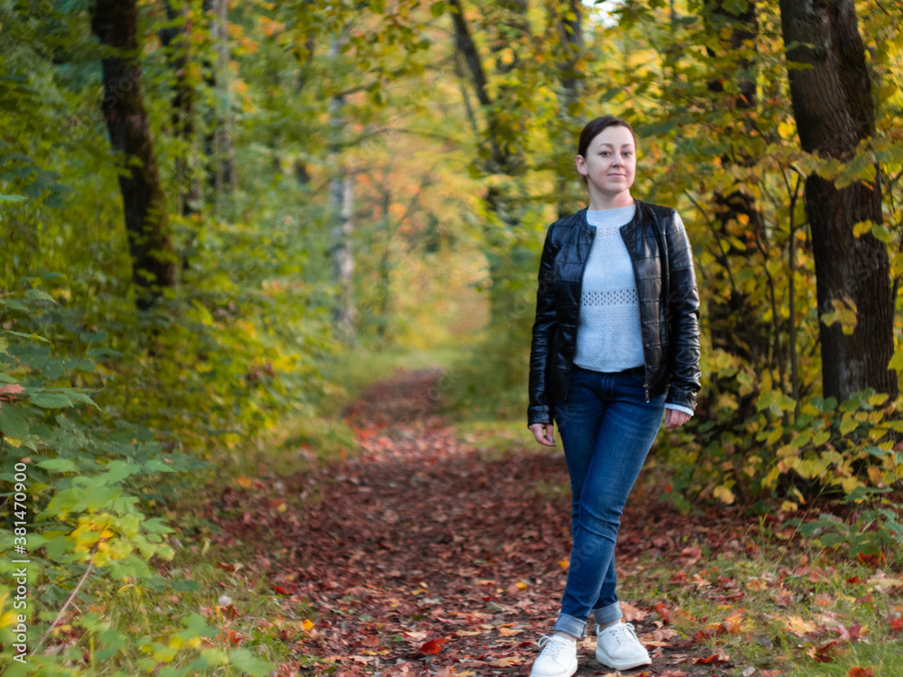 cute woman in leather jacket in autumn Park. beautiful Park alley. bright colors of autumn cute woman in leather jacket in autumn Park. beautiful Park alley. bright colors of autumn