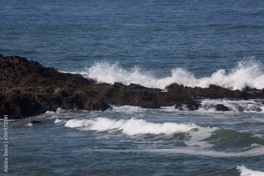 Ocean waves crashing onto rocks at the shore