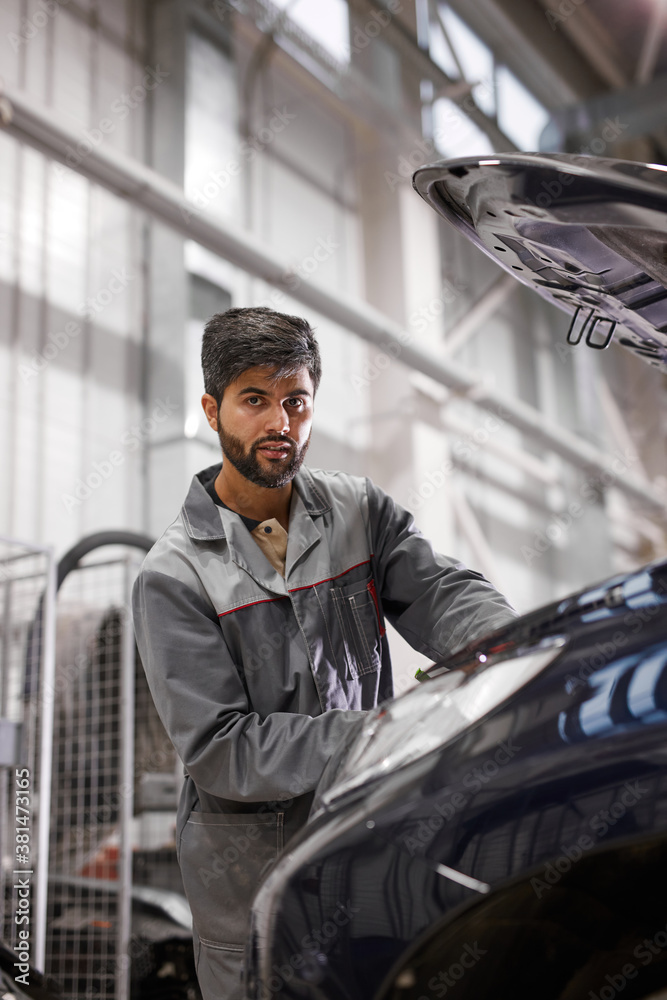 bearded auto mechanic engine performance in the hood of car, going to repair it, conducts diagnostics bearded auto mechanic engine performance in the hood of car, going to repair it, conducts diagnostics