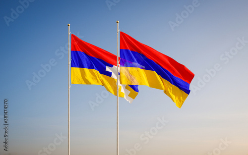 Two waving flag of Nagorno-Karabakh Republic and Armenia against sky background. photo
