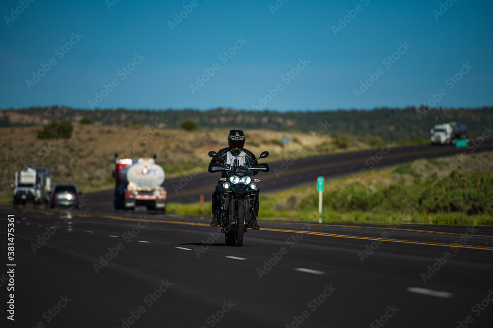 Biker on motorbike, Route 66. Natural american landscape with asphalt road to horizon. Motorbike on the road riding.
