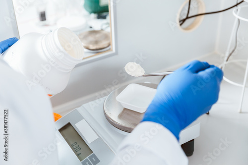 Pharmacist weighing chemical