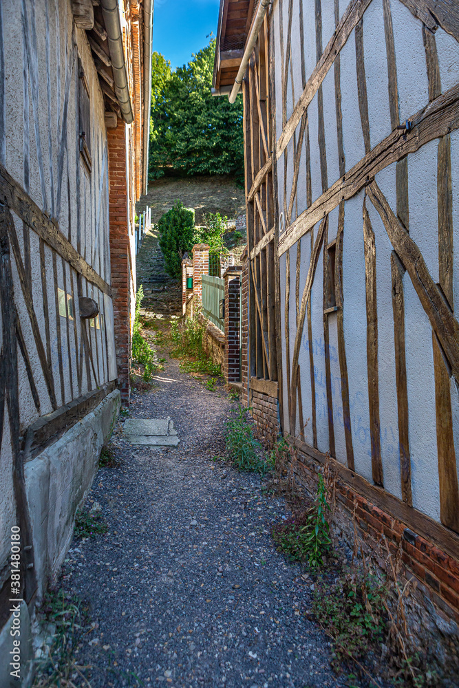 Alley with half timbeed medieval houses at the old town of Bernay, Eure, Normandy, France