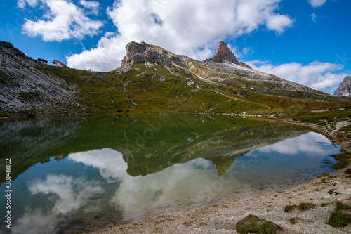an alpine lake with the reflection of the mountains in the Dolomites in South Tyrol, Italy