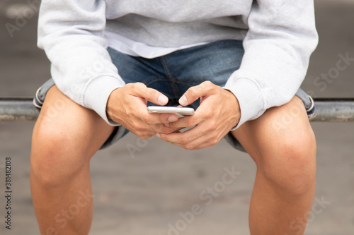 closeup of young man's hands with mobile phone
