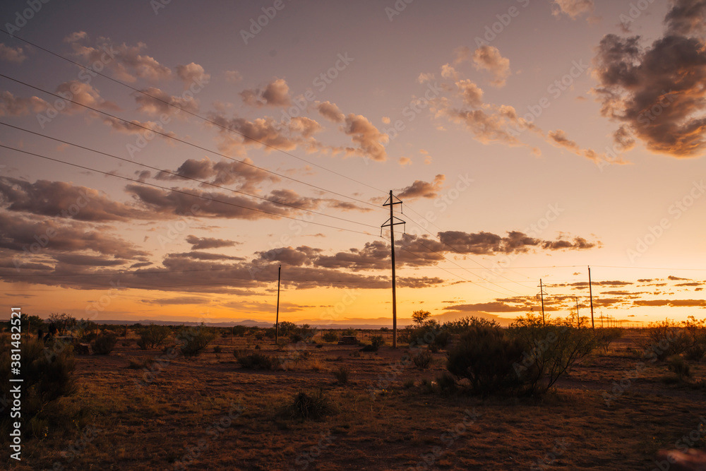 Power lines through the desert at sunrise Power lines through the desert at sunrise