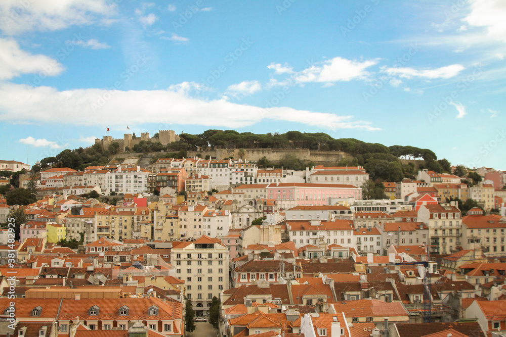 Building and roofs under a mountain in birds-eye-view in Lisbon.