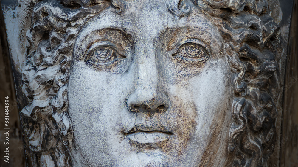 Ancient aged sculpture of beautiful Venetian Renaissance Era woman in Venice, Italy.