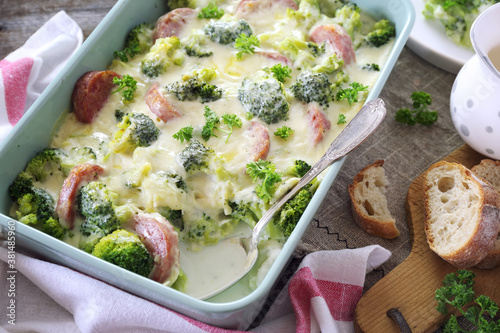 Broccoli gratin with bechamel sauce and sausages photo