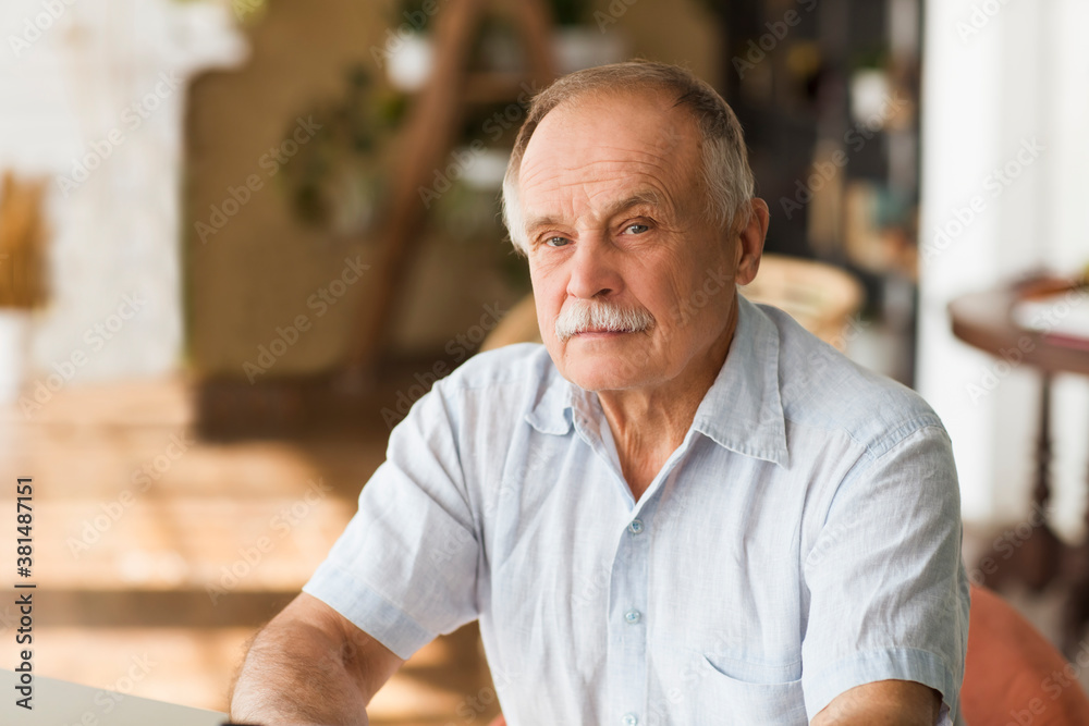 portrait senior man thinking and looking at camera at home portrait senior man thinking and looking at camera at home