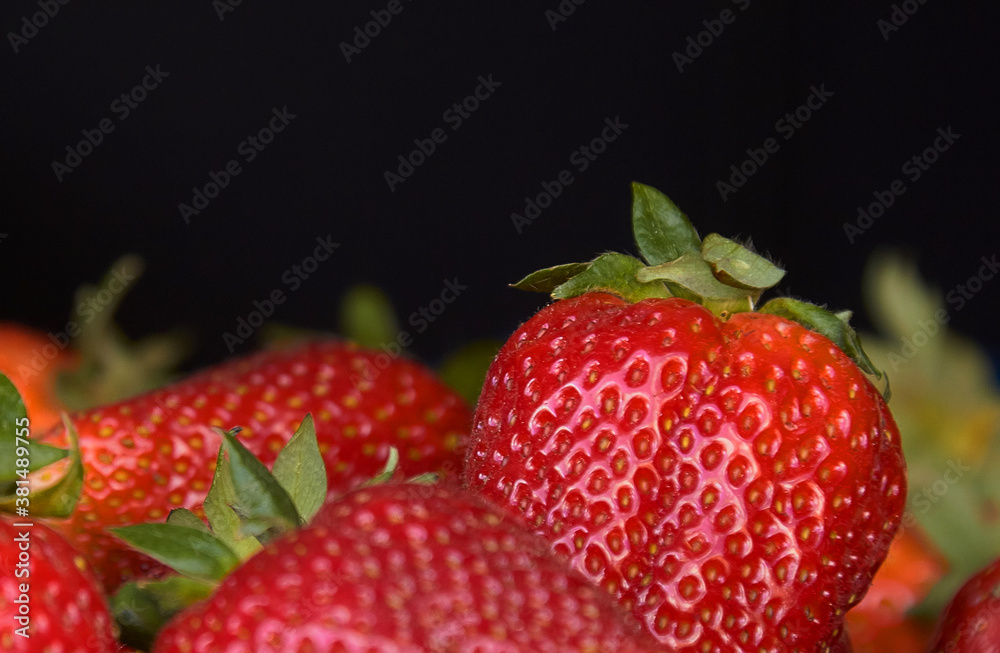 juicy strawberry close-up on a black background juicy strawberry close-up on a black background