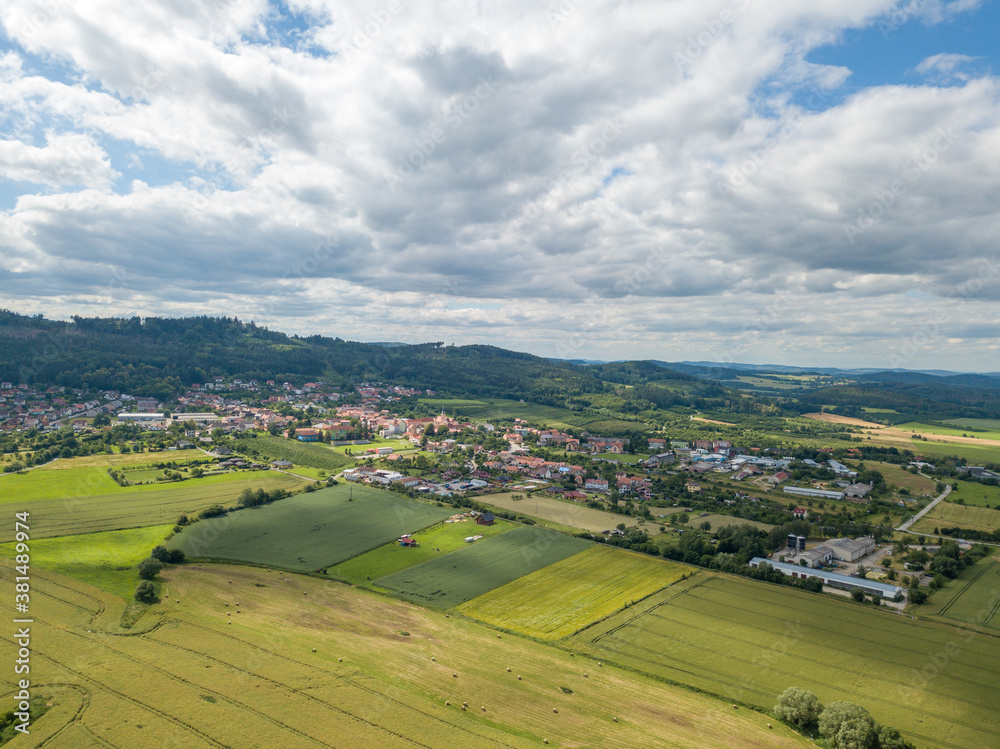 agricultural landscape with a small town in the background photographed from above