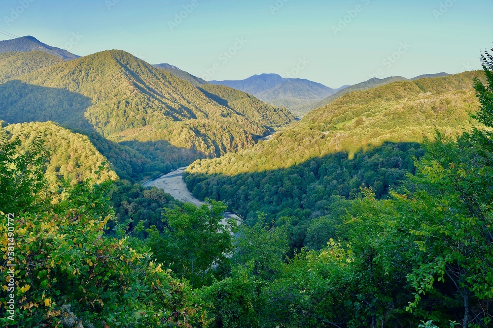 The Shakhe river among the mountains covered with forests, in the Lazarevsky district of Greater Sochi, at sunset
