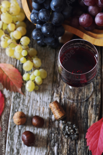 Assortment of fresh grapes and glass of red wine