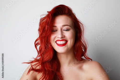Portrait of happy red hair woman, smiling at the camera. Happy mood of the day. Space for your text.