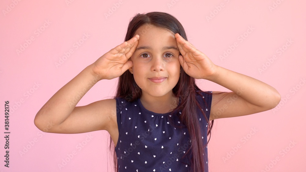 Girl playing hide and seek portrait. Cute little girl open her face with hands. Playing hide and seek