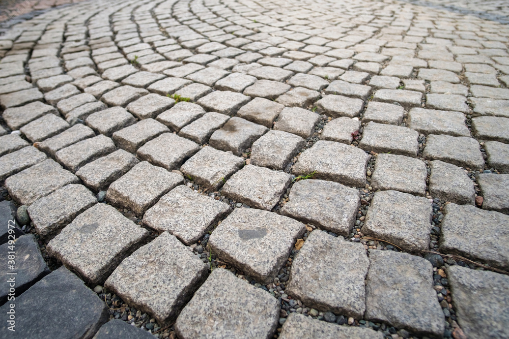 Pavement made from stone cubes in perspective, selective focus