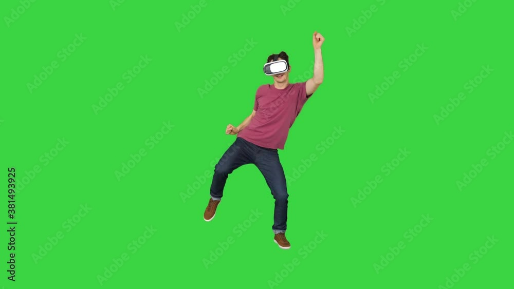 Advanced gamer in casual outfit playing dancing game in VG headset on a Green Screen, Chroma Key. Advanced gamer in casual outfit playing dancing game in VG headset on a Green Screen, Chroma Key.