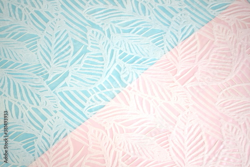 A delicate background consisting of two parts - pink and blue  divided diagonally with the texture of leaves.
