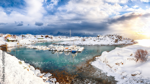 Splendid winter scenery with yachts and boats nier pier in small fishing village and snowy  mountain peaks near Valberg photo