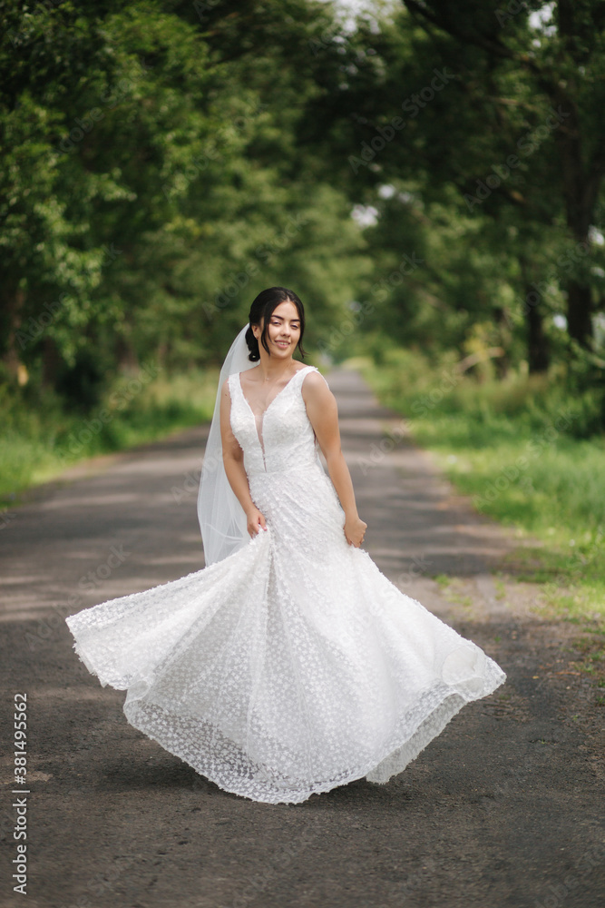 Elegant bride walk in the park and spin arround. Happy bride, wedding day