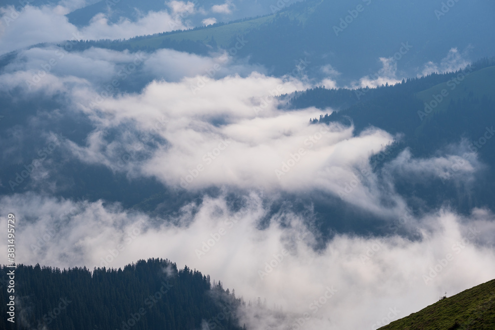 Summer  misty and cloudy morning mountain tops with low clouds. Marmaros Carpathian, Ukraine.